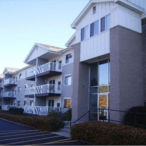 an apartment building with a street in front of it