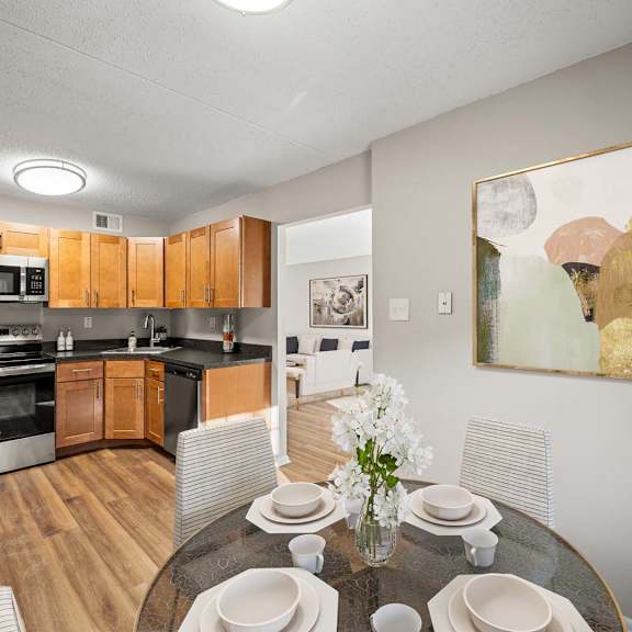 a modern kitchen with a dining table set for four.
