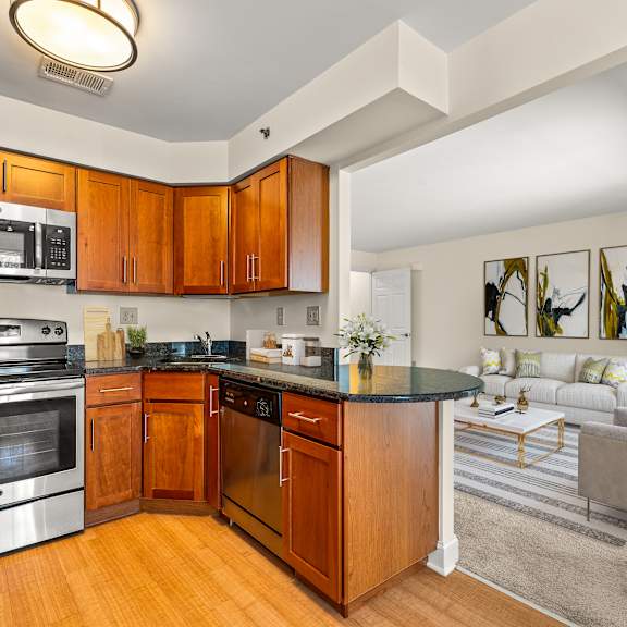 a modern kitchen with wooden cabinets and stainless steel appliances.