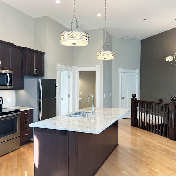 a kitchen with stainless steel appliances and a marble counter top