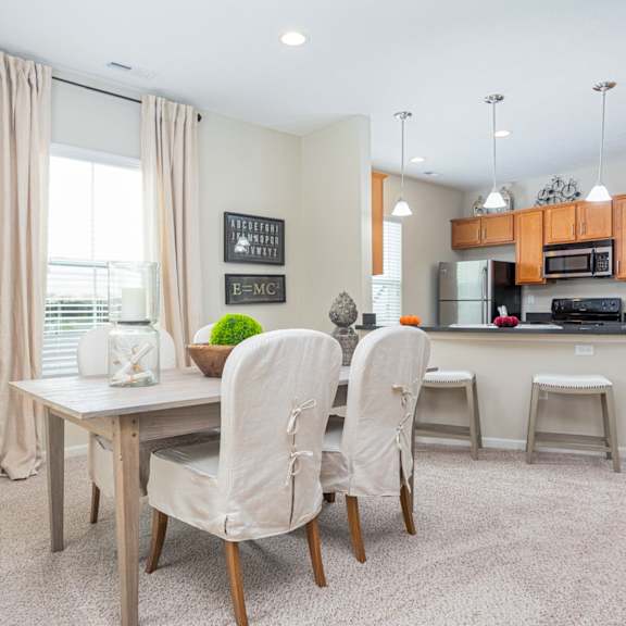 a dining room with a table and chairs.