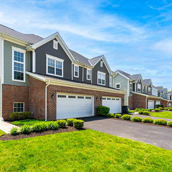 a row of houses with a clear blue sky above them.