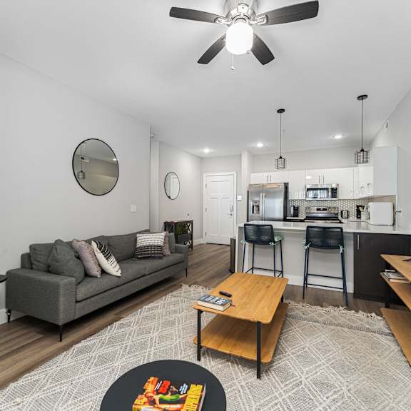 a living room with a grey couch and a wooden coffee table.
