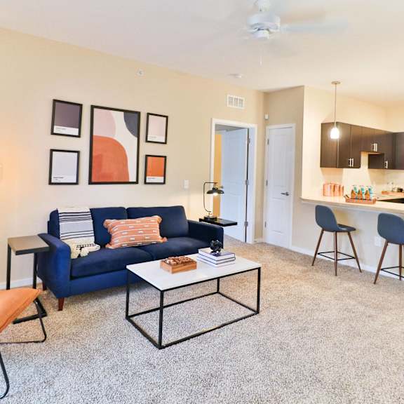 a living room with a blue couch and a coffee table