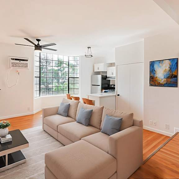 a living room with a beige couch and a coffee table.