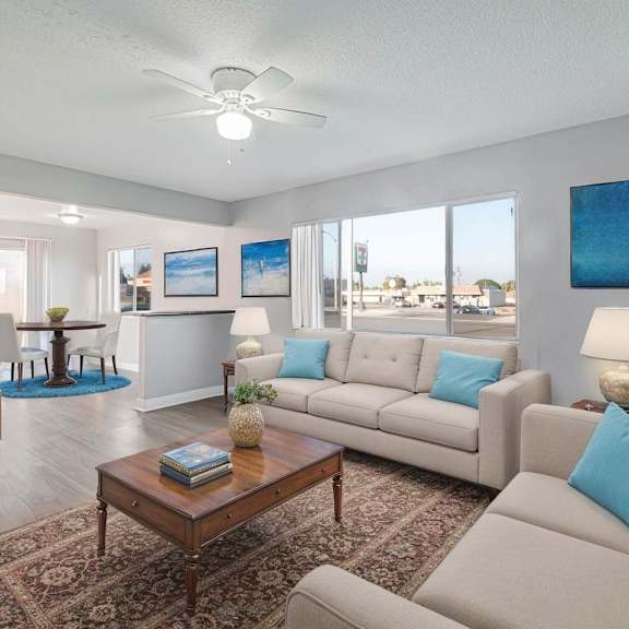 a living room with a brown coffee table and a grey couch.