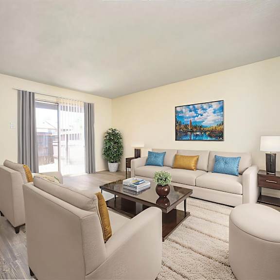 a living room with a white couch, a coffee table, and a painting on the wall.