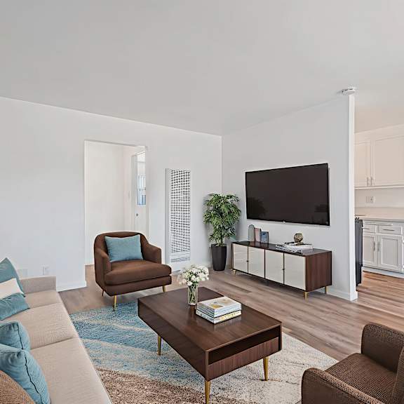 a living room with a brown chair and a brown sofa.
