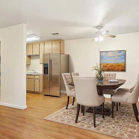 a kitchen with a dining table and chairs.