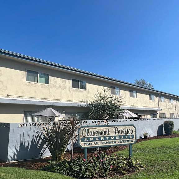 a building with a sign that says "carmelton pacifica apartments" in front of it.