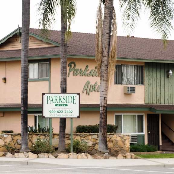 a building with a sign that says parkside apartments.