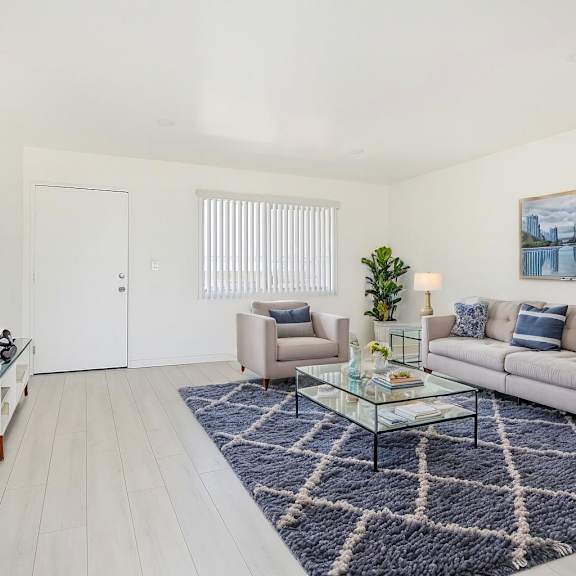 a living room with a couch, chair, and coffee table.
