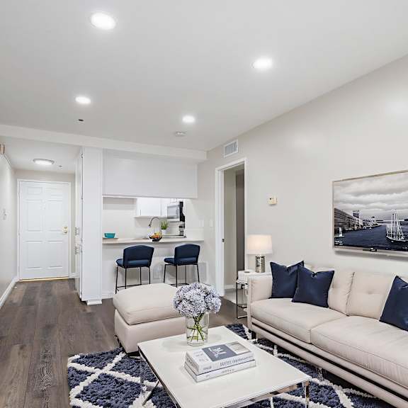 a modern living room with a white sofa and a coffee table.