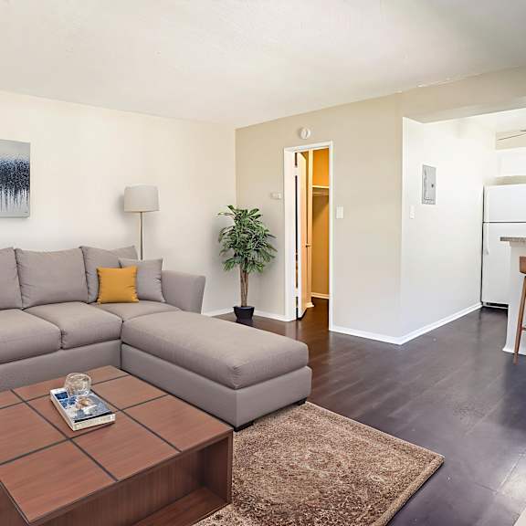 a living room with a grey couch and a brown coffee table.