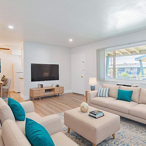 a living room with a white couch and a television.