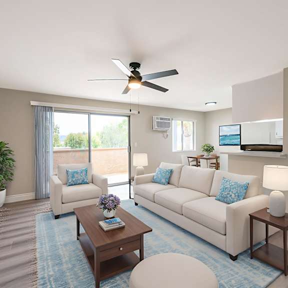 a living room with a couch, a coffee table, and a ceiling fan.