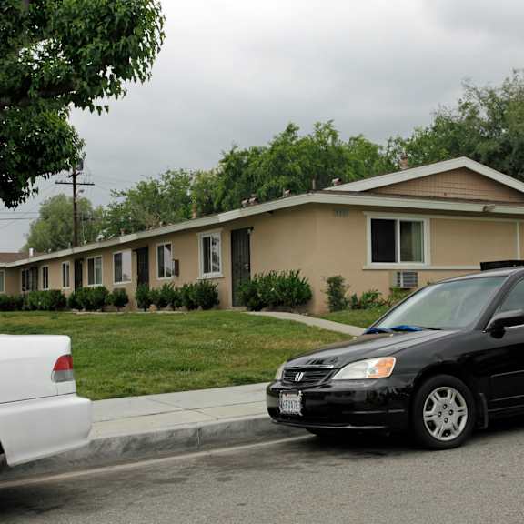 two cars parked in front of a house.