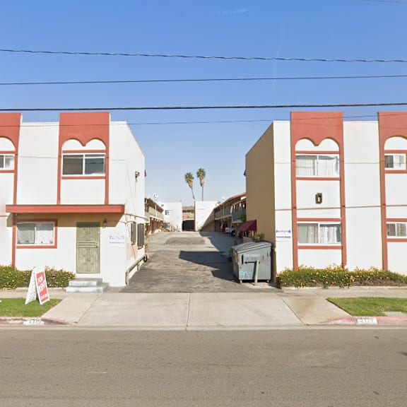 a street view of a row of red and white buildings.