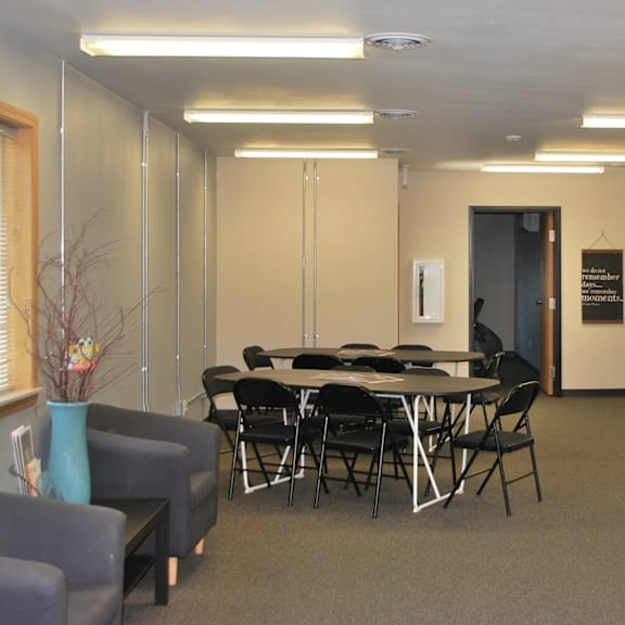 a conference room with a table, chairs, and a blue vase.