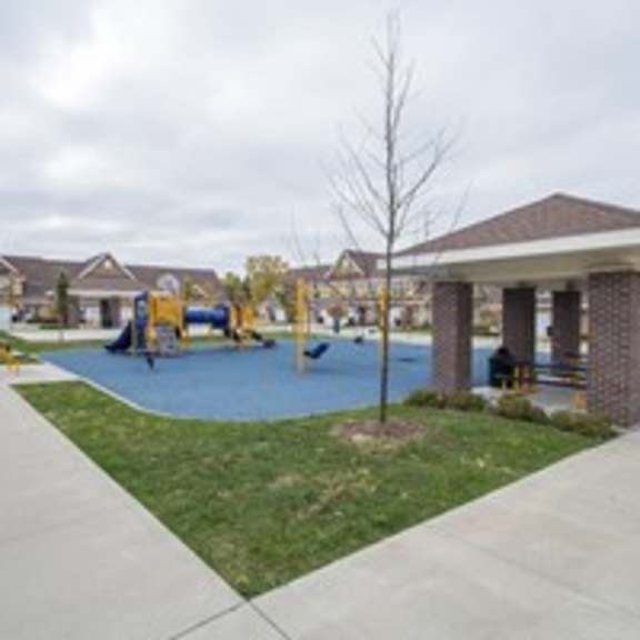 a playground with a yellow slide and a red circle.