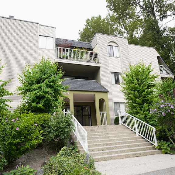 a house with a staircase leading to the front door.