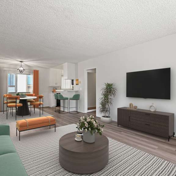 a living room with a green sofa, a wooden coffee table, and a flat-screen tv mounted on the wall.