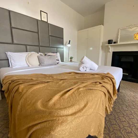 a bedroom with a bed and a fireplace