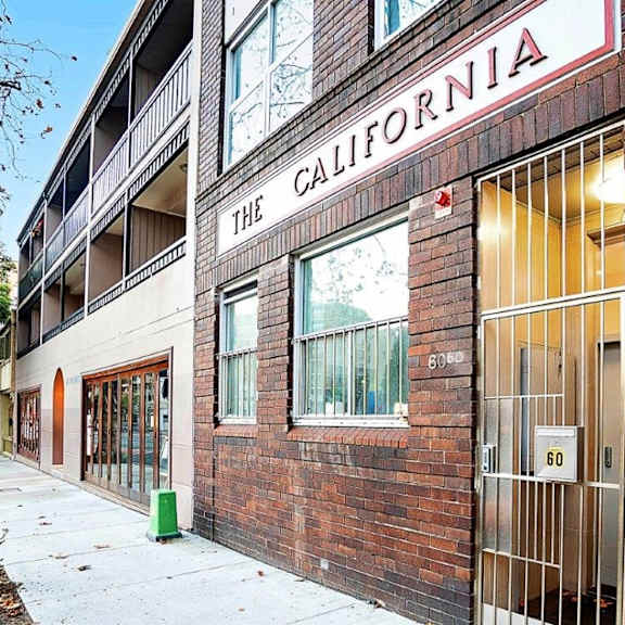 a brick building with a sign that reads the