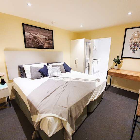 a bedroom with a bed and a desk and a closet