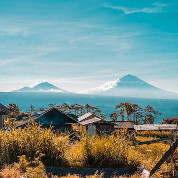 a small village with mountains in the background