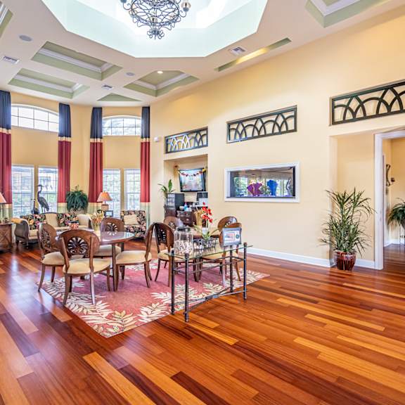 a large room with a wooden floor and a chandelier hanging from the ceiling.