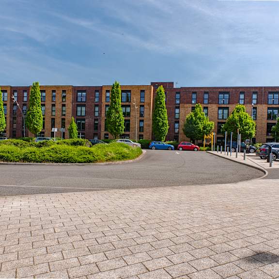 A large building with a parking lot in front of it.