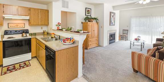 A kitchen with white appliances and brown cabinets.