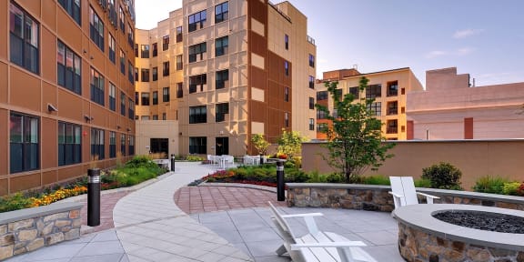 a courtyard with chairs and a fire pit in front of a building at Valley and Bloom, Montclair, 07042