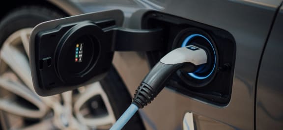 an electric car is being charged at a charging station