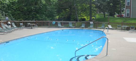 A small pool with a metal railing around it.