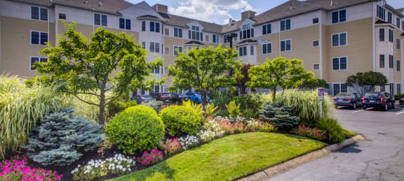 a garden in front of an apartment building
