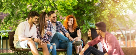 a group of people sitting on a park bench