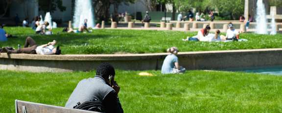 A person is sitting on a bench in a park.