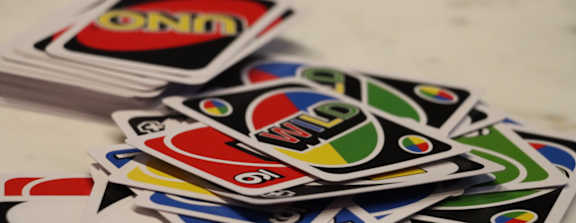 A pile of UNO cards is stacked on top of each other.
