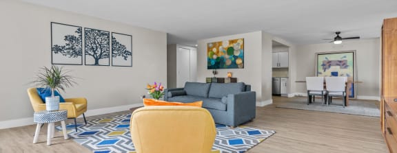 our apartments offer a living room with a gray couch and yellow chairs