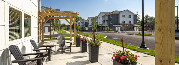 an outdoor patio with tables and chairs outside of a building