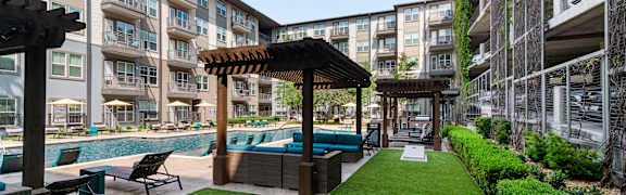 A well-maintained outdoor area with a pool and lounge chairs.
