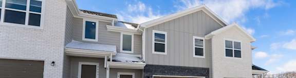 A house with a grey roof and white walls.