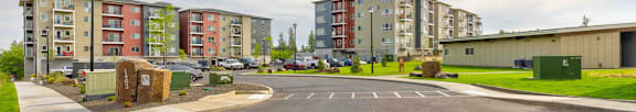 A parking lot in front of apartment buildings.