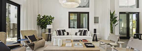 A modern living room with a large sofa, armchairs, and a coffee table.