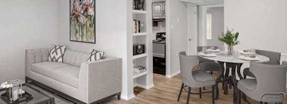 a living room and dining room with a table and chairs