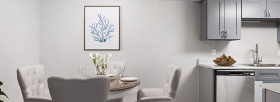 a kitchen and dining area with a table and chairs and a sink at The Onyx Apartments, Alabama