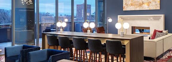 A modern living room with a fireplace and a view of the city.