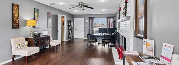 Leasing office with a white chair and a wooden floor.